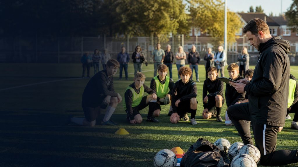 Coach and club administrator managing how to reduce no shows at youth soccer practice at a youth sports session